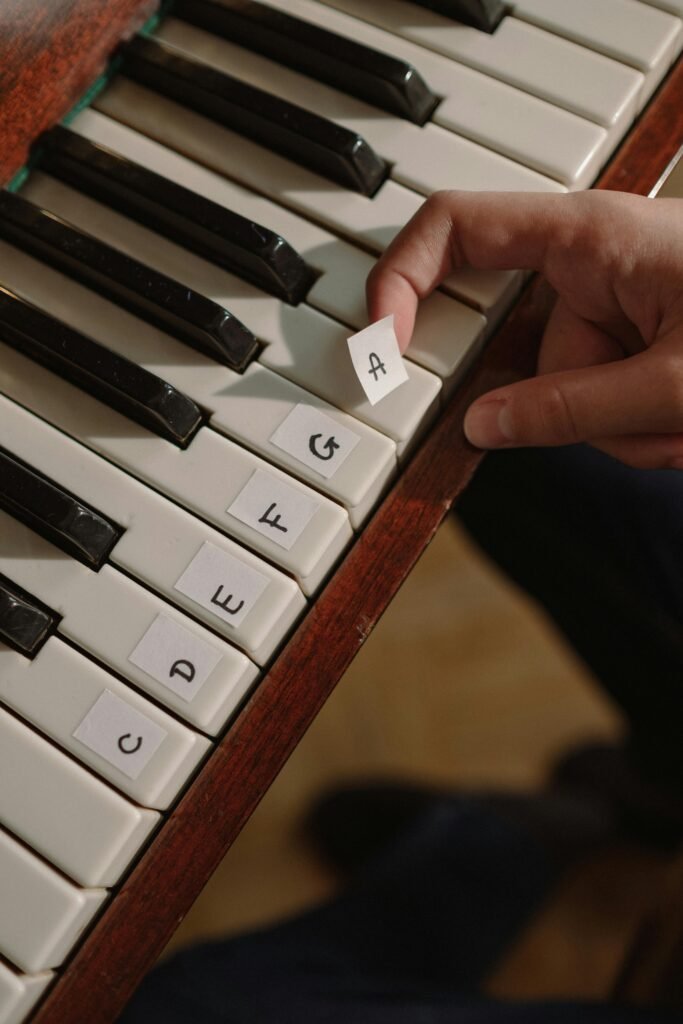 pexels-photo-10222320-10222320 Close-up of fingers arranging letters on a piano keyboard.